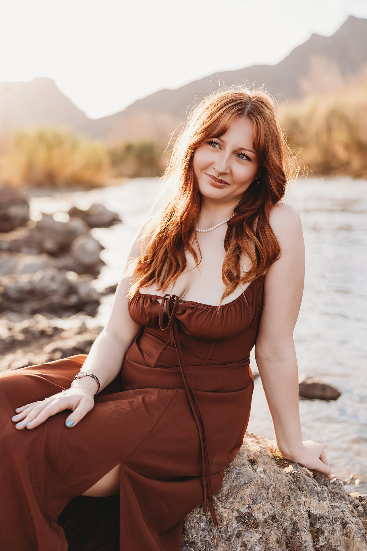 Girl with red hair posing at salt river for senior session by phoenix photographer