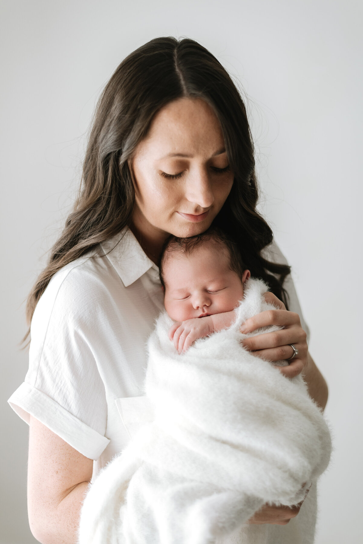Mother holding her newborn son at billingshurst newborn photoshoot