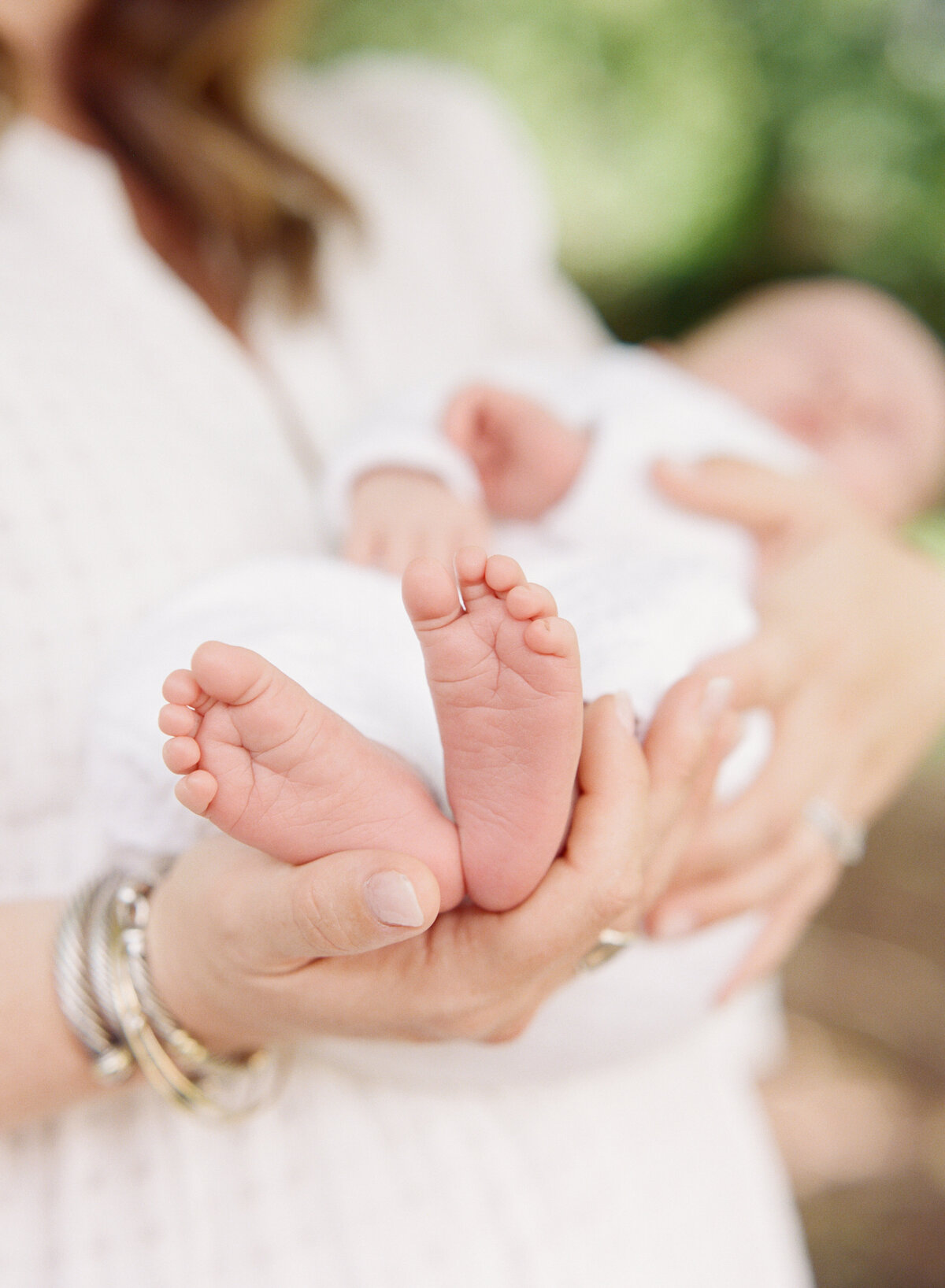 Mom holds baby toes in Mebane NC newborn session. Photographed by Raleigh Newborn Photographer A.J. Dunlap Photography.