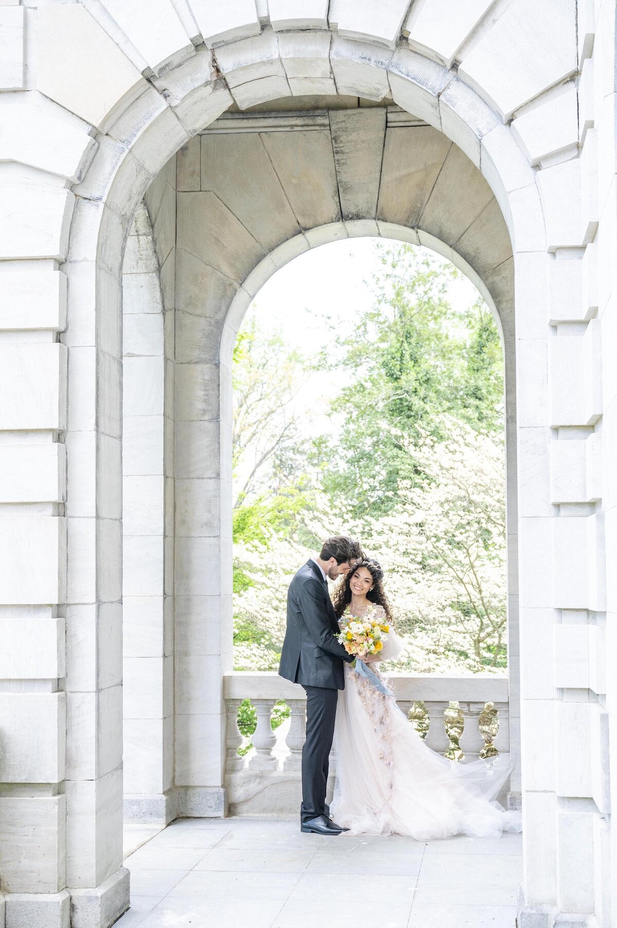 Bride and groom under arch