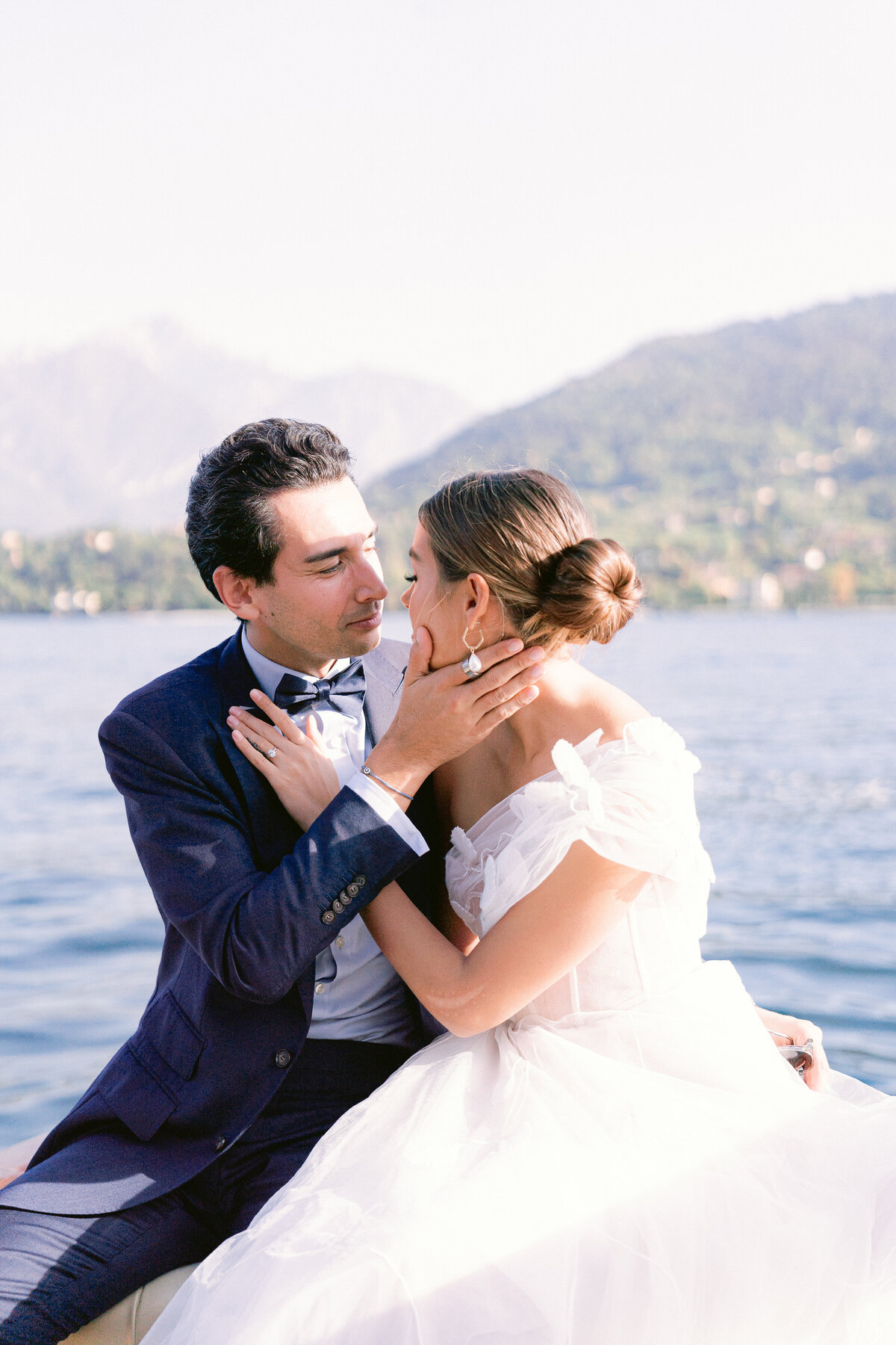 Couple in an embrace on board a private boat on Lake Como, Italy