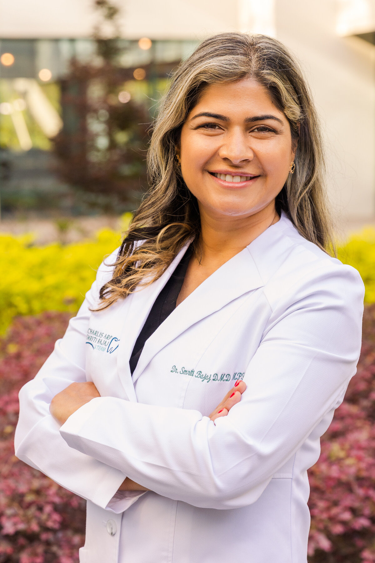 denist doctor wearing a white blouse arms crossed during portraits session