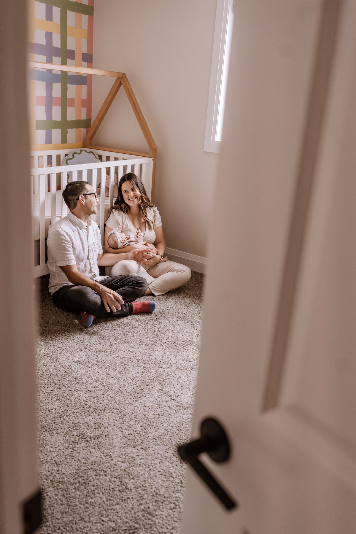 parents with baby in nursery