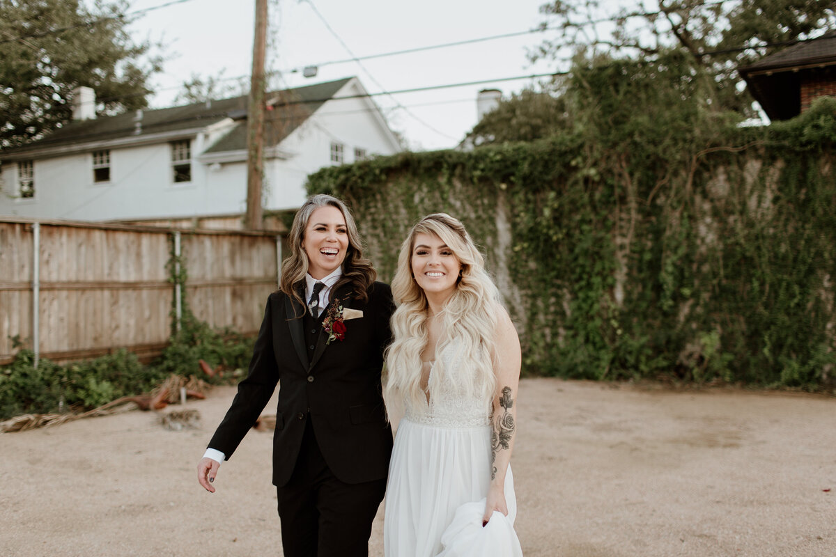 A happy candid of an LGBTQ+ couple at AvantGarden in Houston Texas. Captured by Fort Worth wedding photographer, Megan Christine Studio