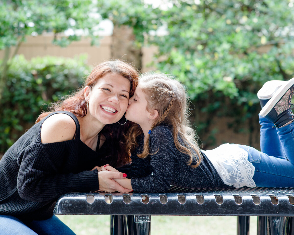 family portrait of daughter kissing motherby Lucas Mason Photography in Orlando, Windermere, Winder Garden area