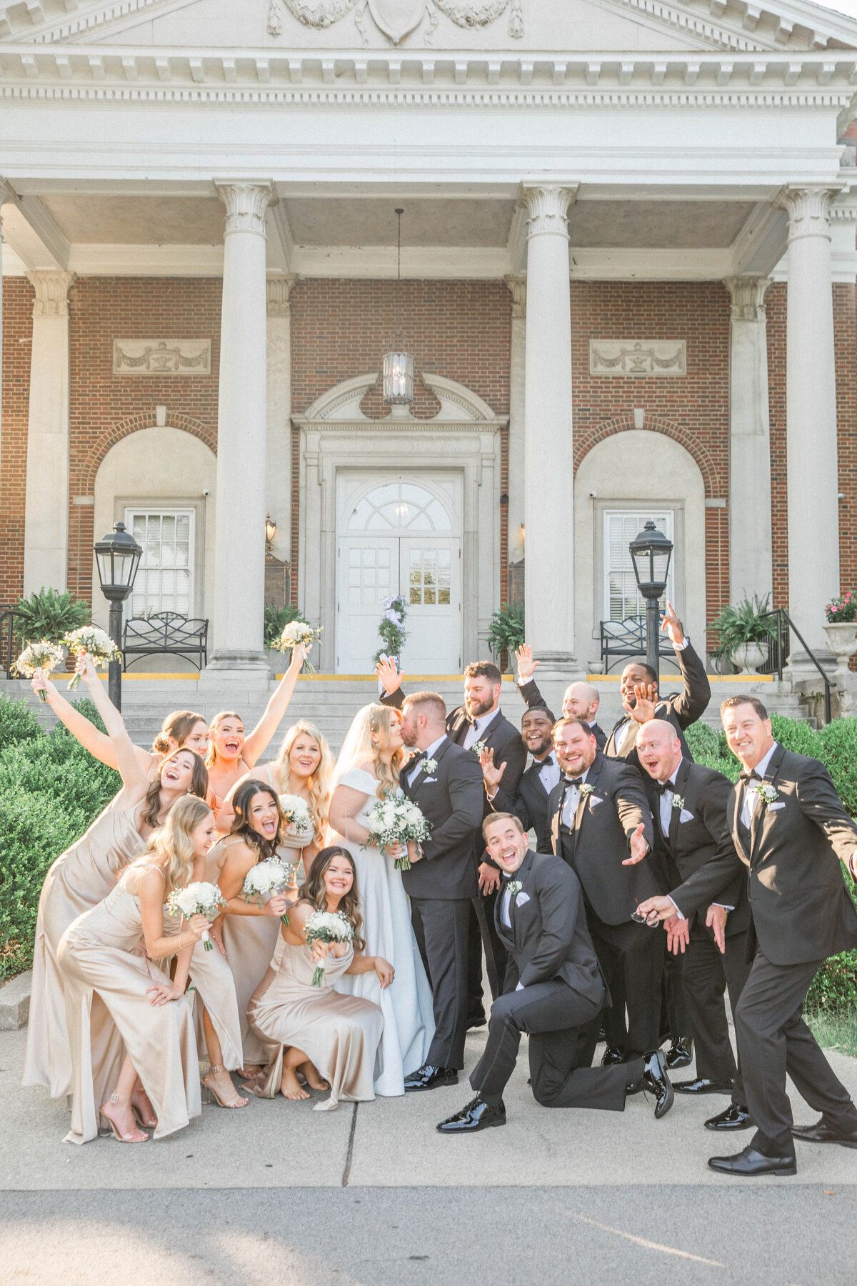 fun bridal party photo taken at a black tie wedding