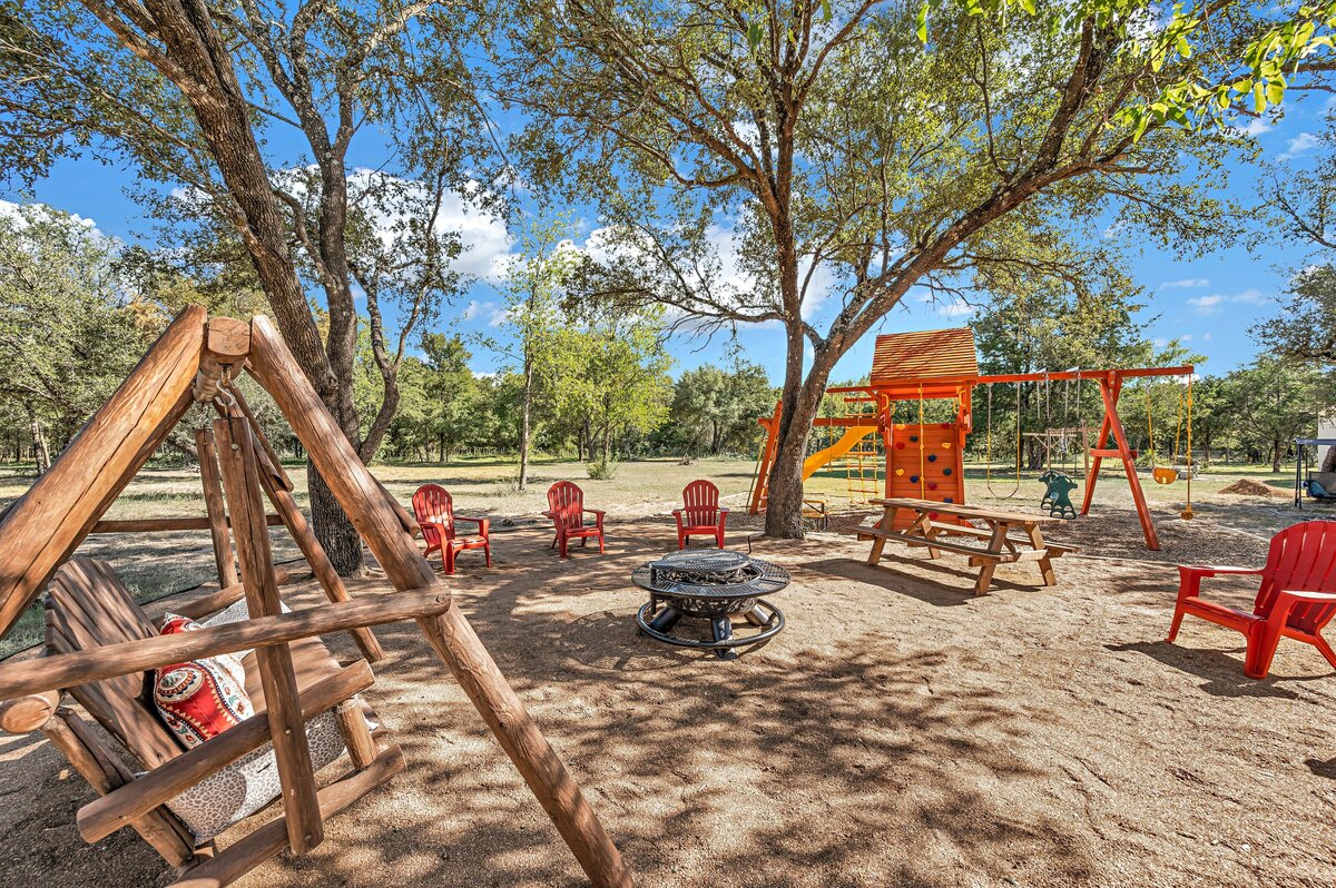 Firepit and full-size playground at this 7-bedroom, 5-bathroom farmhouse that sleeps 21 on a secluded acreage just 15 minutes from downtown Waco, TX