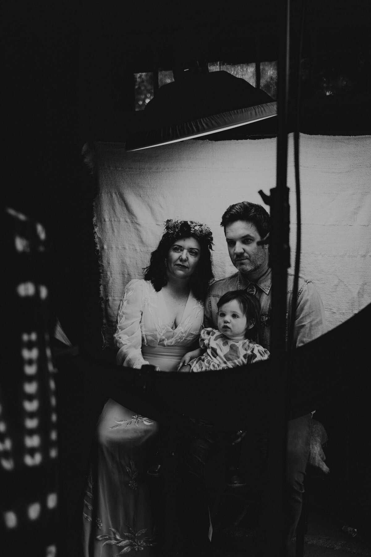newlyweds getting a tintype portrait done during their wedding reception