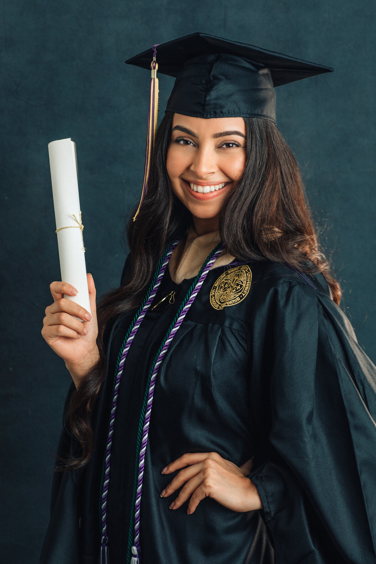 Graduation Portrait Of Young Woman In Black Toga Showing Her Diploma Los Angeles