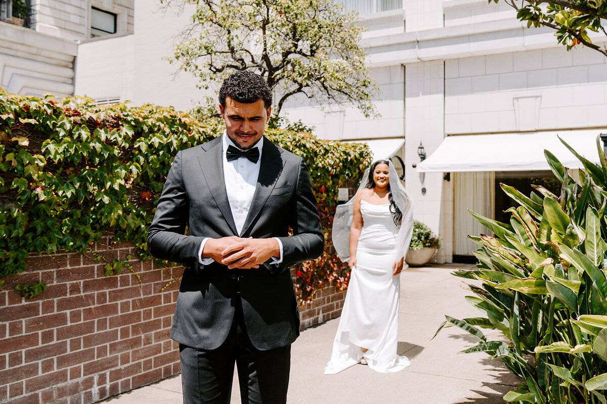 newlyweds pose silly on boardwalk