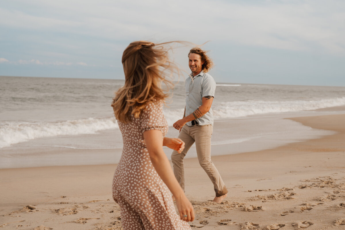 A engaged couple on the beach in North Carolina.