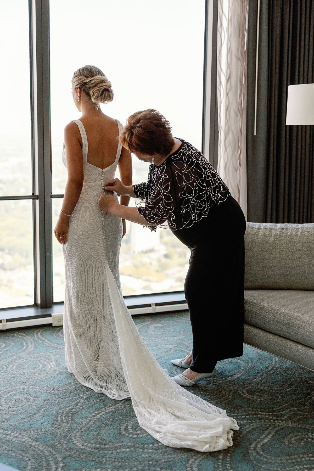 Brides mom helping with the dress