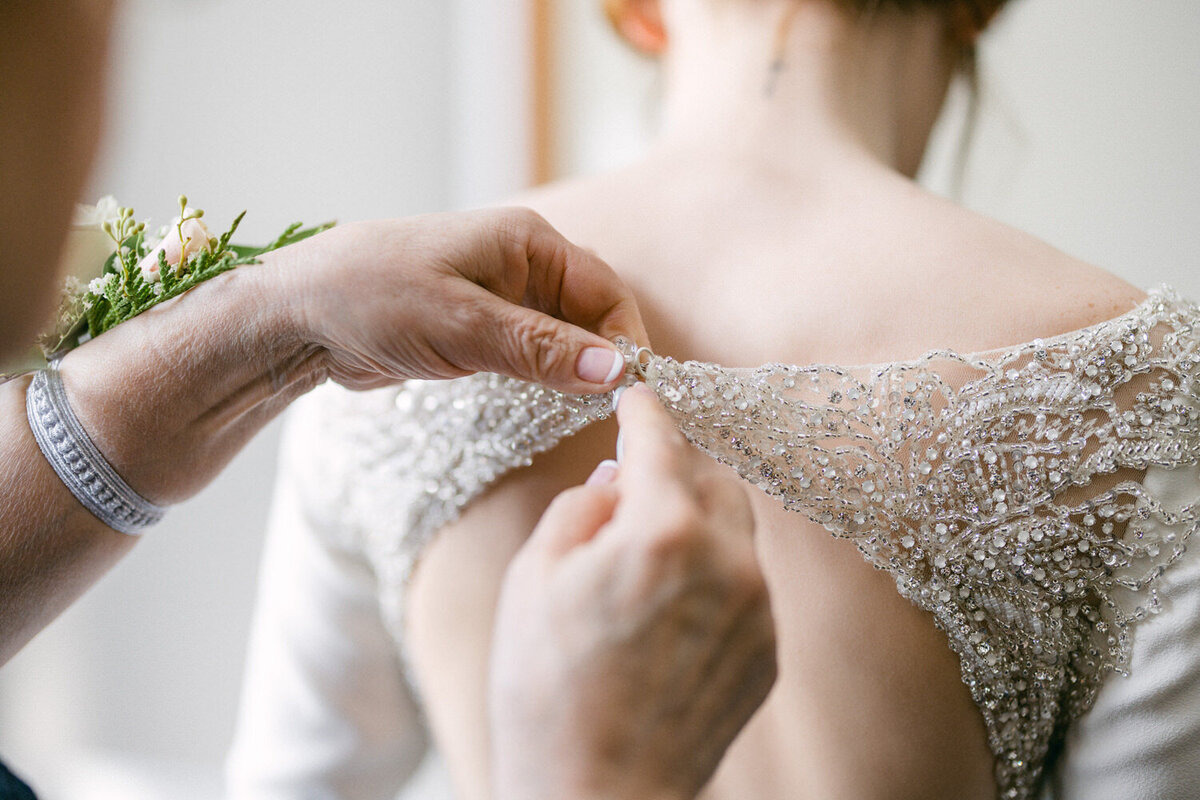 Natalie-Shawn-wedding-dress-being-done-up-with-bride-009
