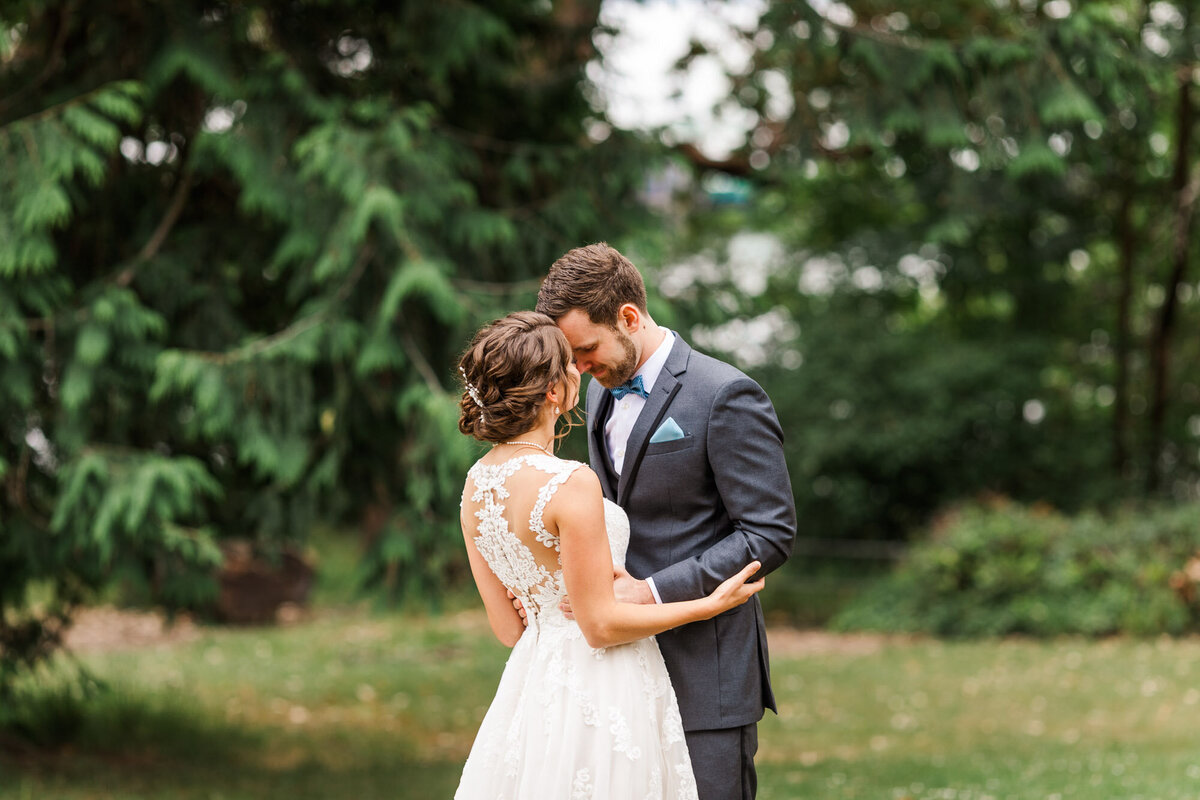 Bride-and-groom-have-a-quiet-moment-together-at-Lincoln-Park-in-West-Seattle-before-their-ceremony-at-Fauntleroy-Hall-photo-by-Joanna-Monger-Photography