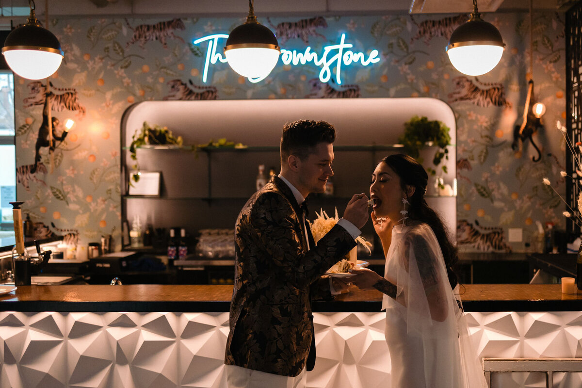 Moody image of bride and groom in front of the bar, image by OR Imagery, authentic and intimate wedding photographer in Calgary, Alberta. Featured on the Bronte Bride Vendor Guide.