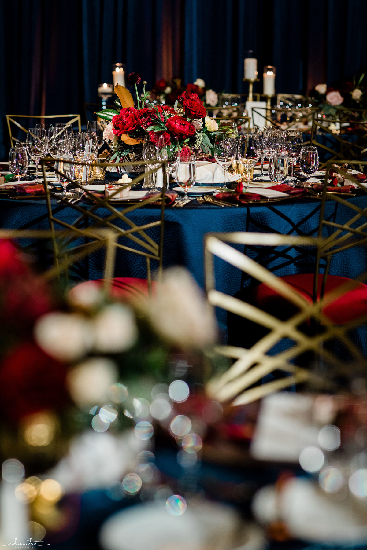 winter centerpiece with red flowers and gold Chameleon chairs
