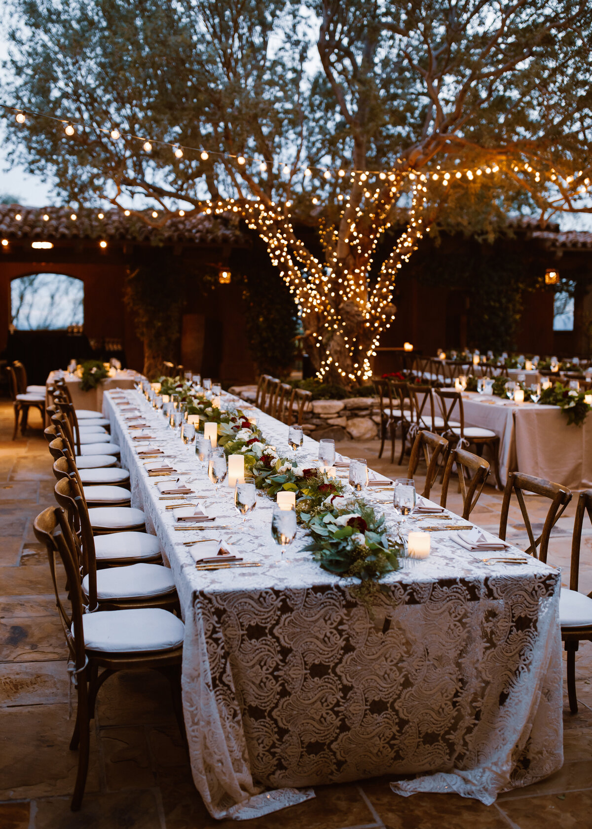 A wedding reception is set on a lace tablecloth in Spain.