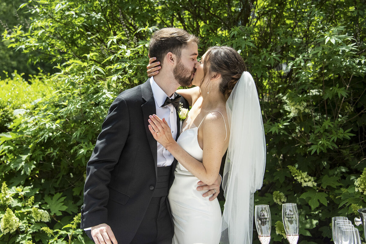 Couple kissing after cutting cake at Homewood Asheville