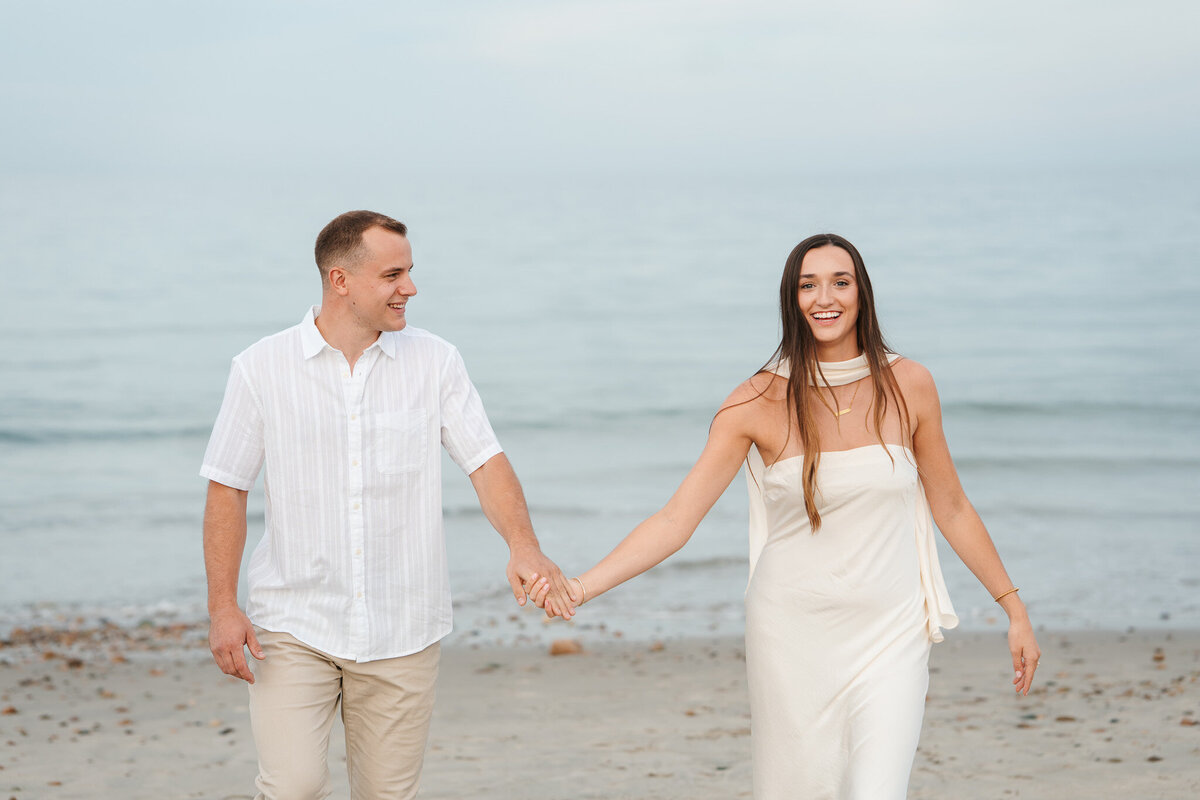 Candid ocean engagement portraits in New England with relaxed emotional storytelling