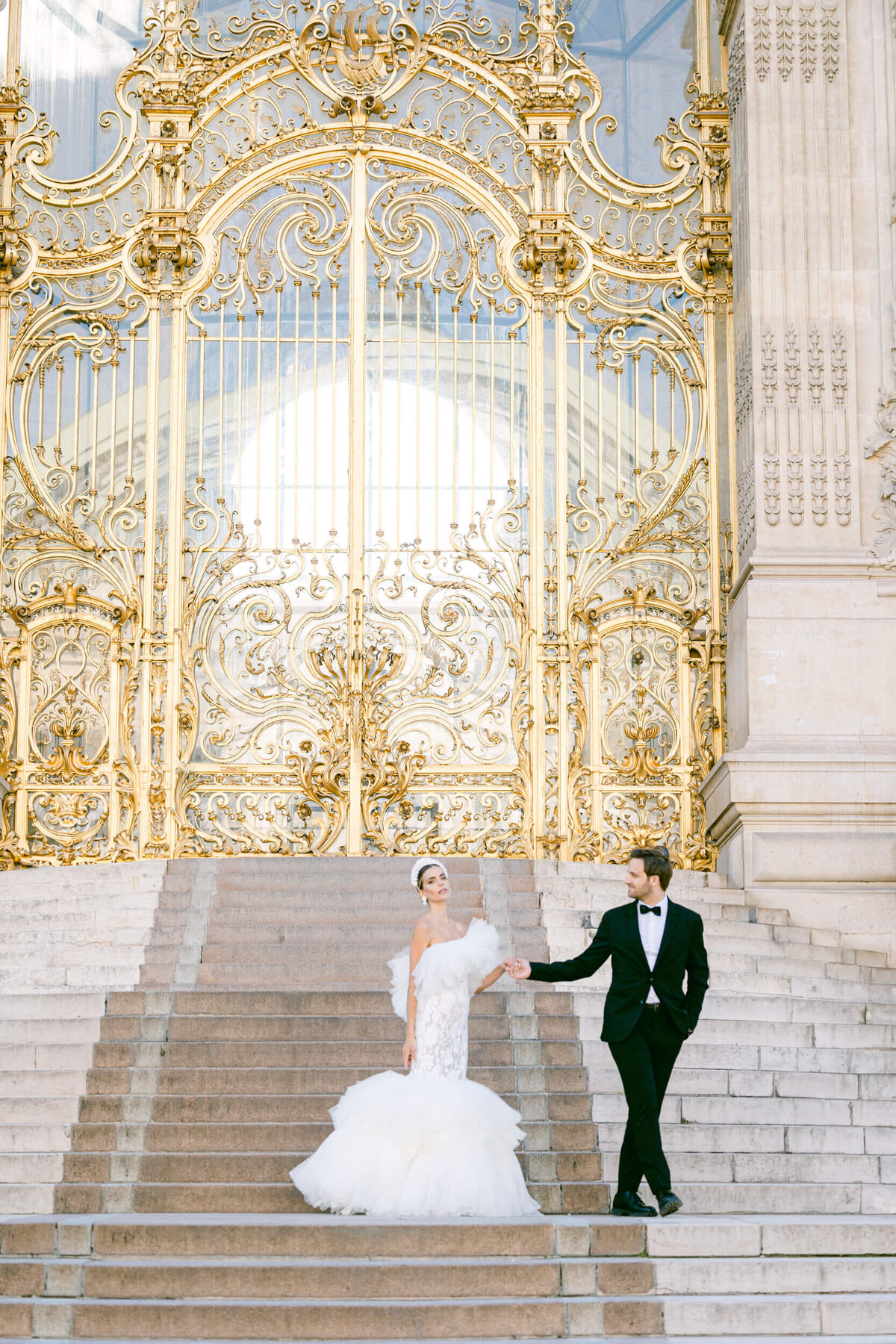 A wedding photo of a bride in her white dress in the streets of Paris in France.