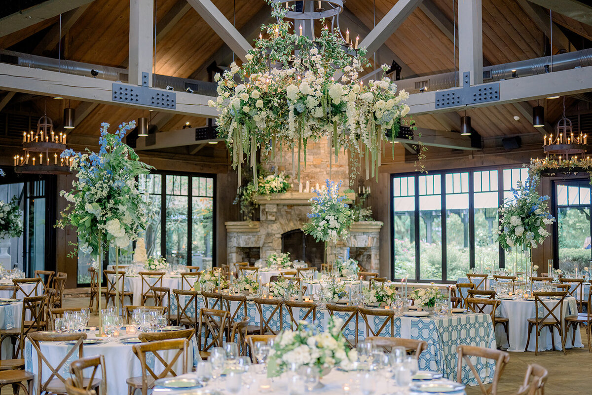 Suspended floral chandelier with cascading greenery, white roses, and hydrangeas at a luxury wedding reception at Old Edwards Inn in Highlands, North Carolina.