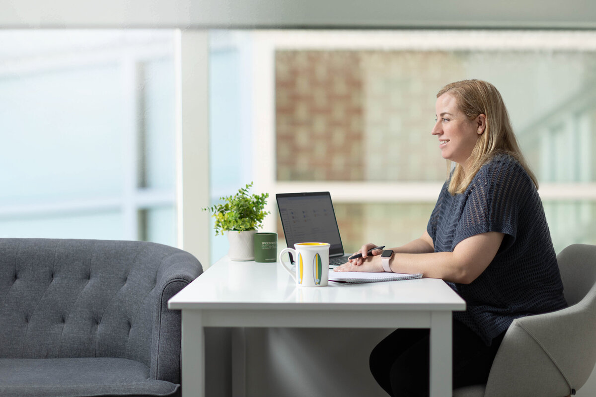 Businesswoman at desk in front of window
