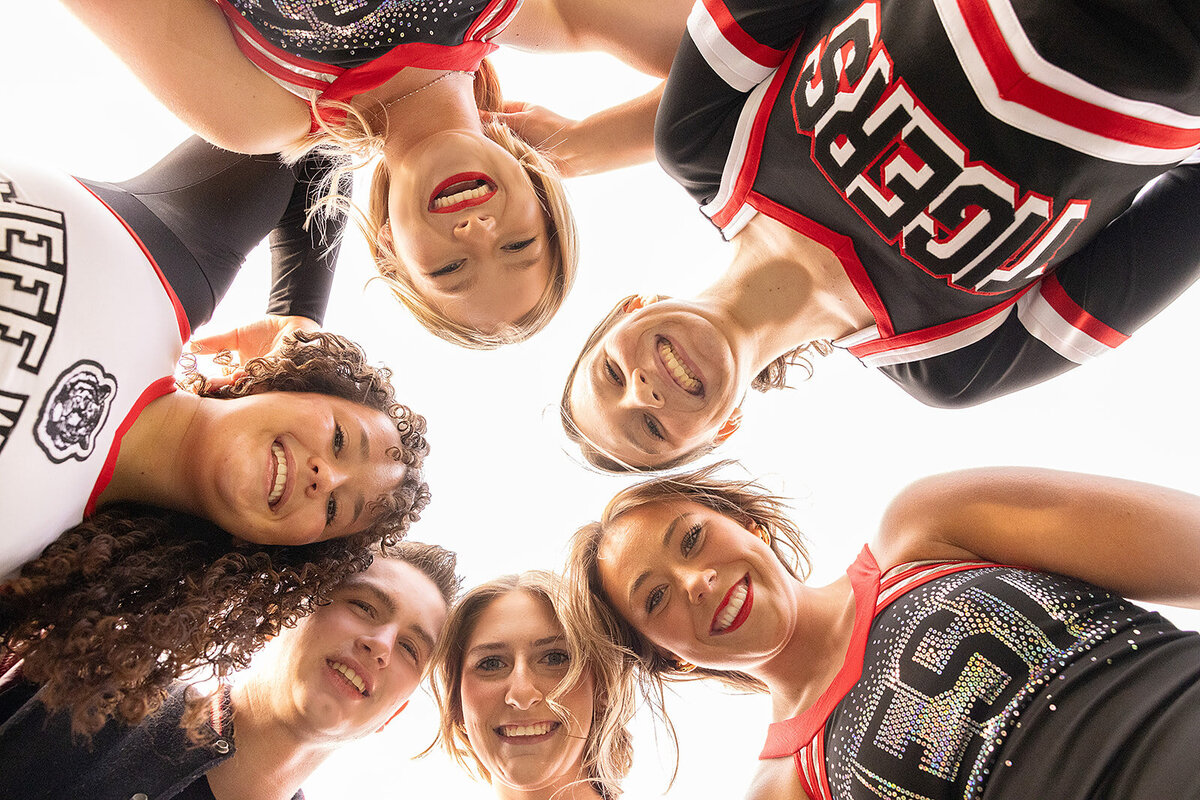 five cheerleaders looking down cool angle