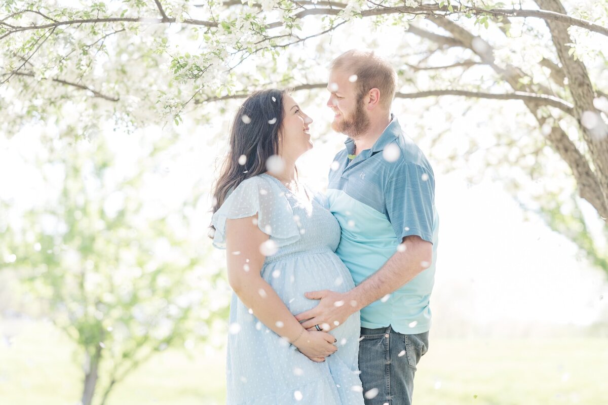 a husband embracing his pregnant wife
