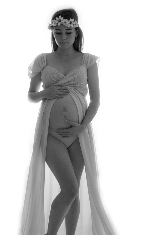 pregnant woman in maternity gown showing off baby belly - Townsville Maternity Photography by Jamie Simmons