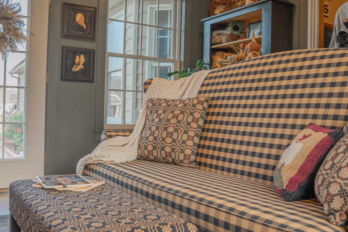 Early American checkered textile sofa bench with textile of black and golden tan