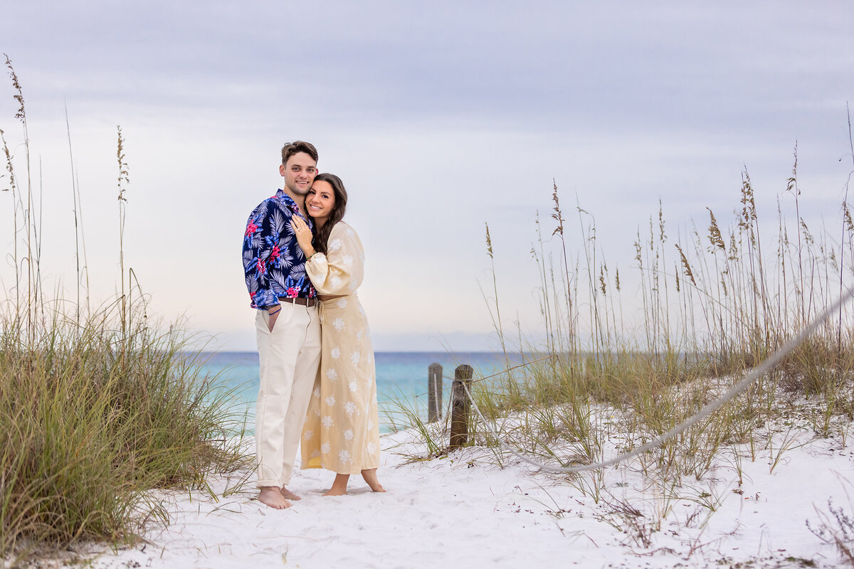 newly engaged couple posing on trail to Grayton Beach.