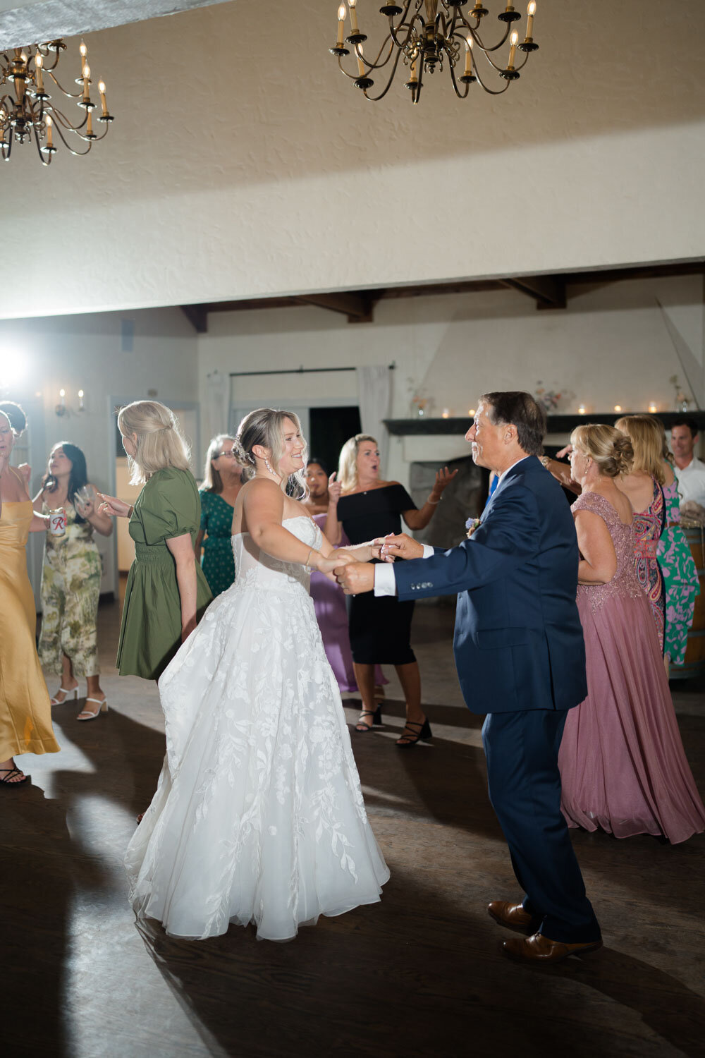 Bride dancing with a guest at a lively reception
