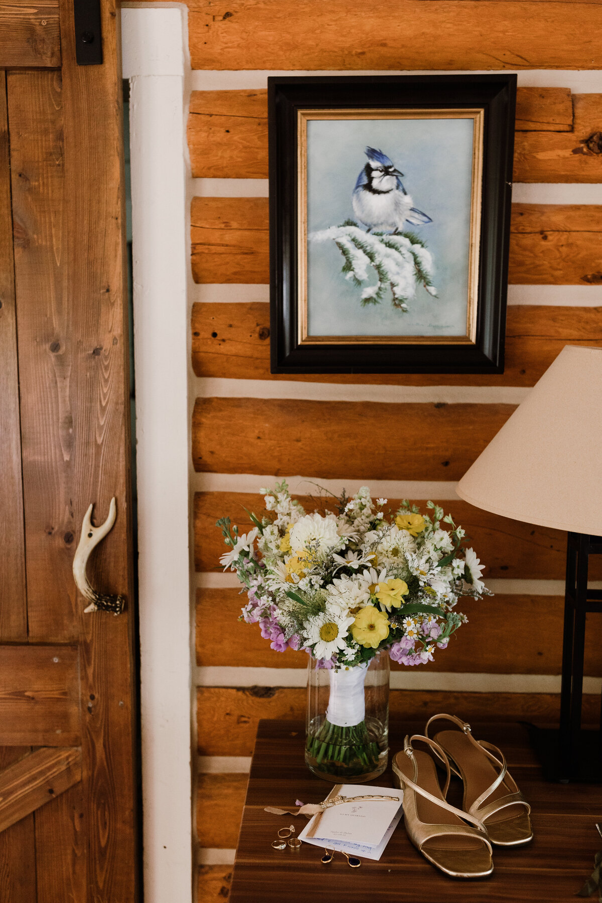Bridal bouquet and wedding shoes  and vow book at Dallenbach Ranch Colorado Wedding