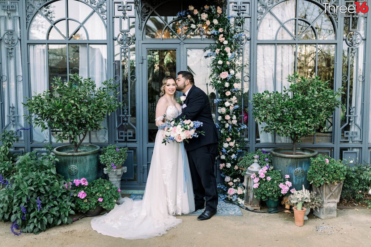 Groom kisses his Bride's cheek