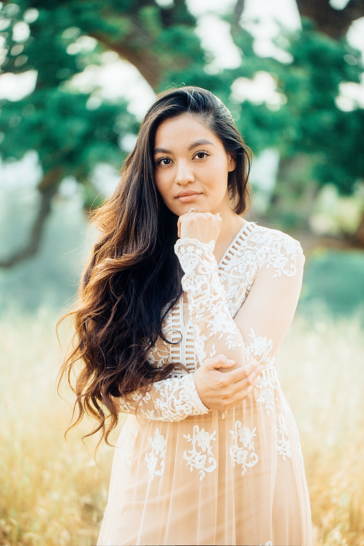 Engagement Photograph Of  Woman In Orange Dress With Her Hand On Her Face Los Angeles