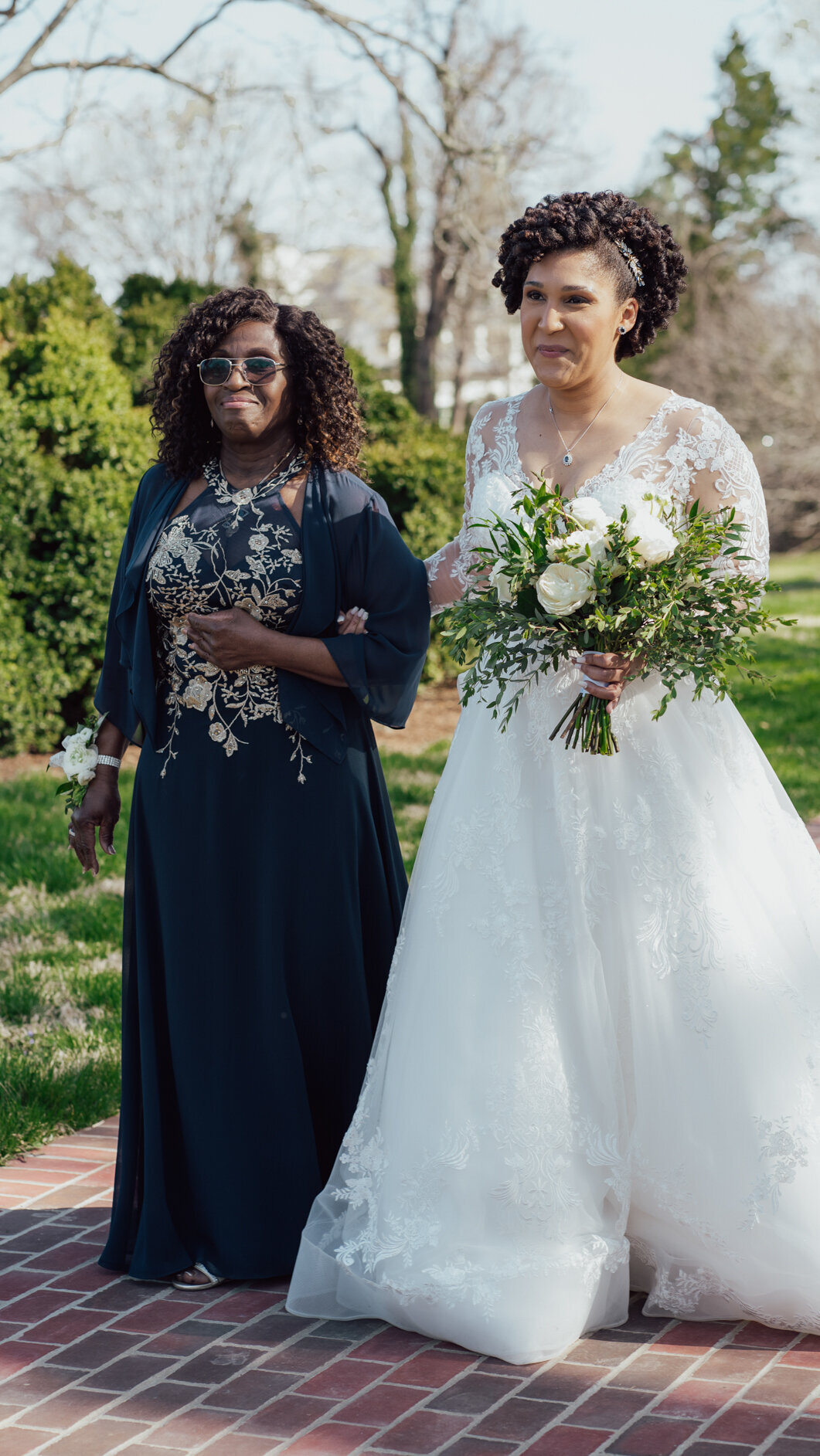 Bride is led down the aisle by her mother at River Farm, Alexandria, Virginia.