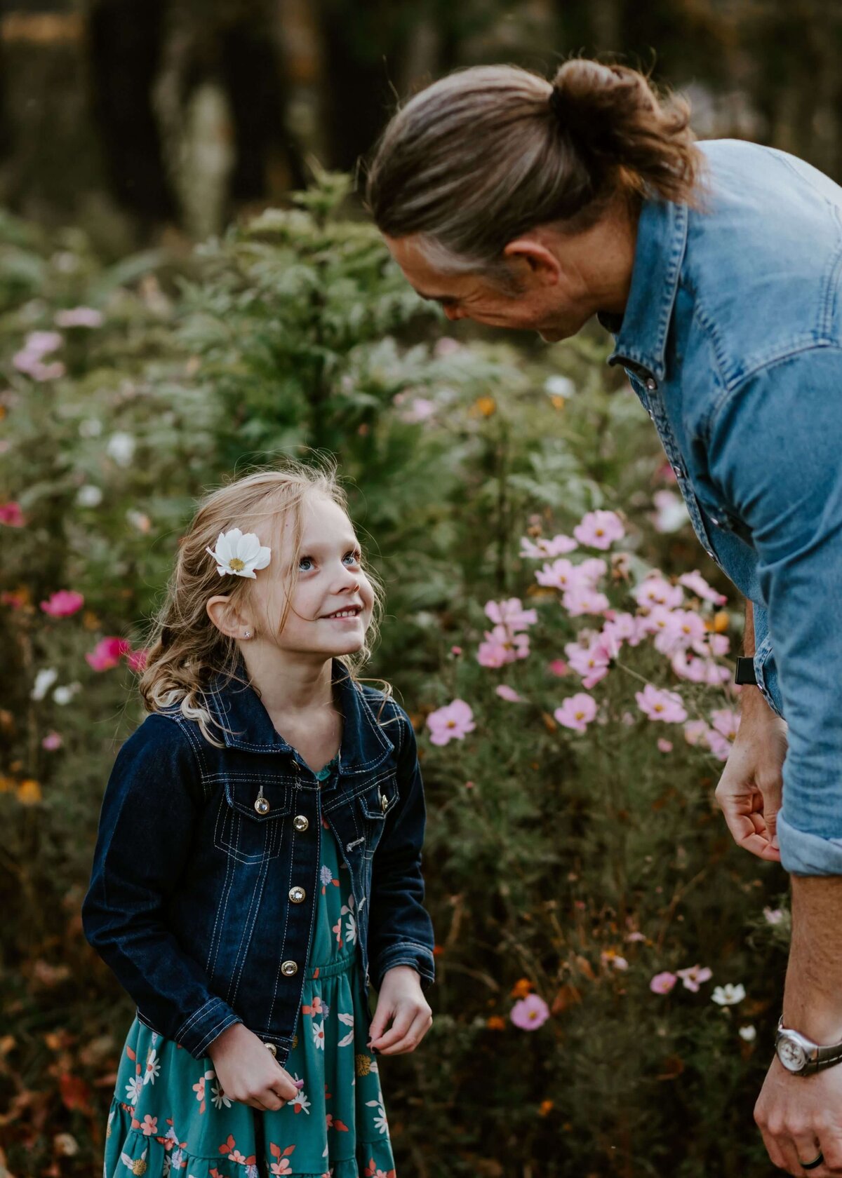 A father and his daughter in a field of flowers captured by a Pittsburgh family photographer.