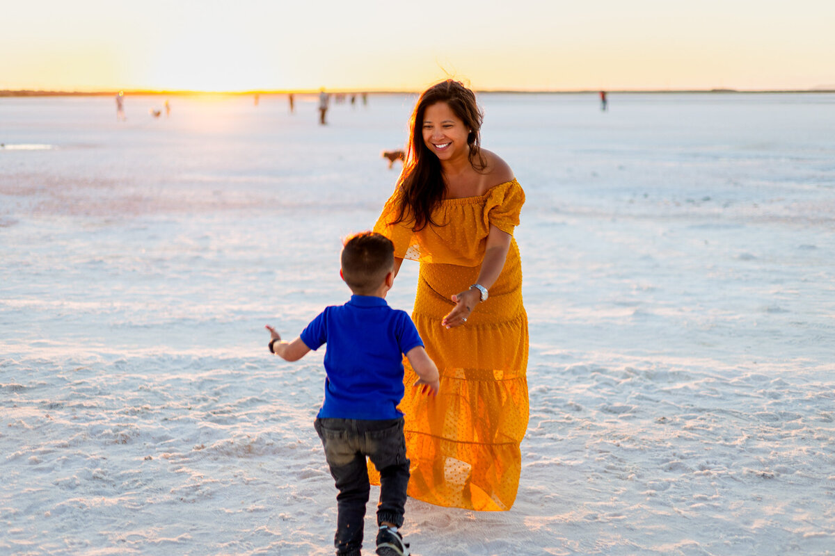Little boy running into his mom’s arms at sunset on white salt flats – Bay Area Family Portfolio - Ellobelle Photography