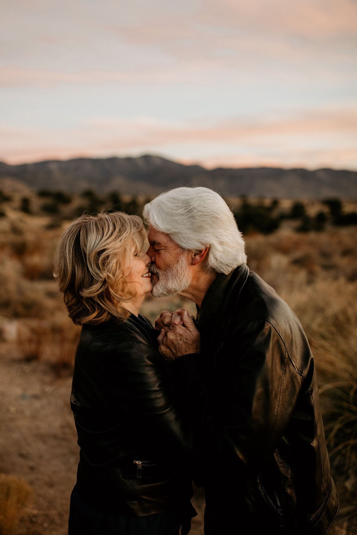 middle aged couple kissing in the desert