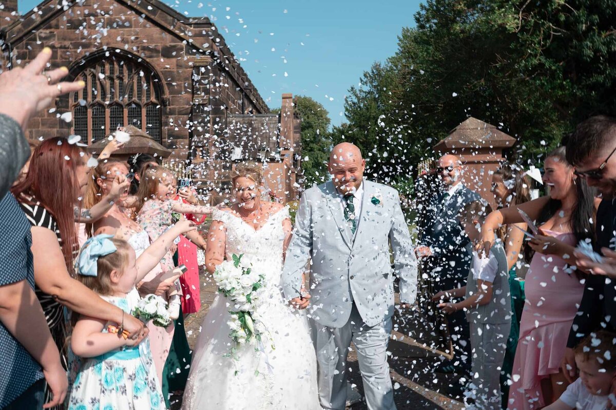 Wedding confetti exit outside St Mary’s Church, Northwich – joyful candid moment.