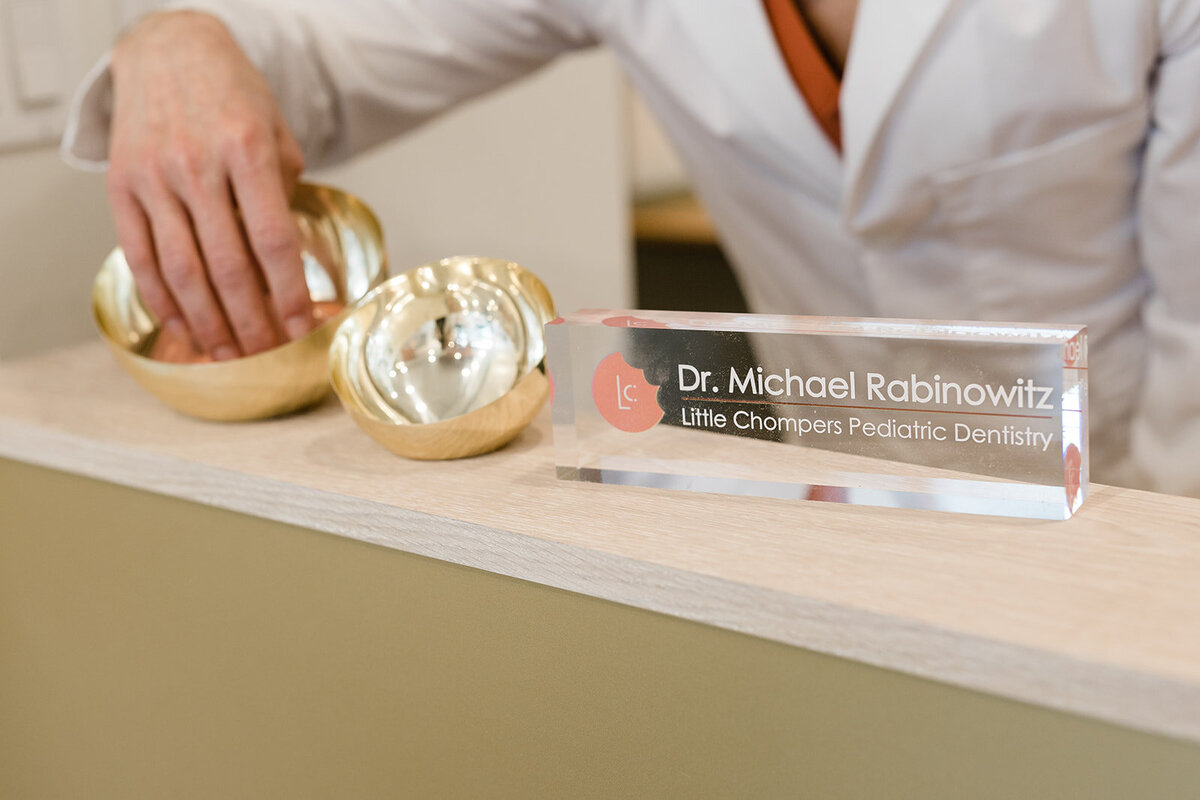 Metallic and glass details are featured on the desk of Dr. Michael Rabinowitz of Little Chompers Pediatric Dentistry.