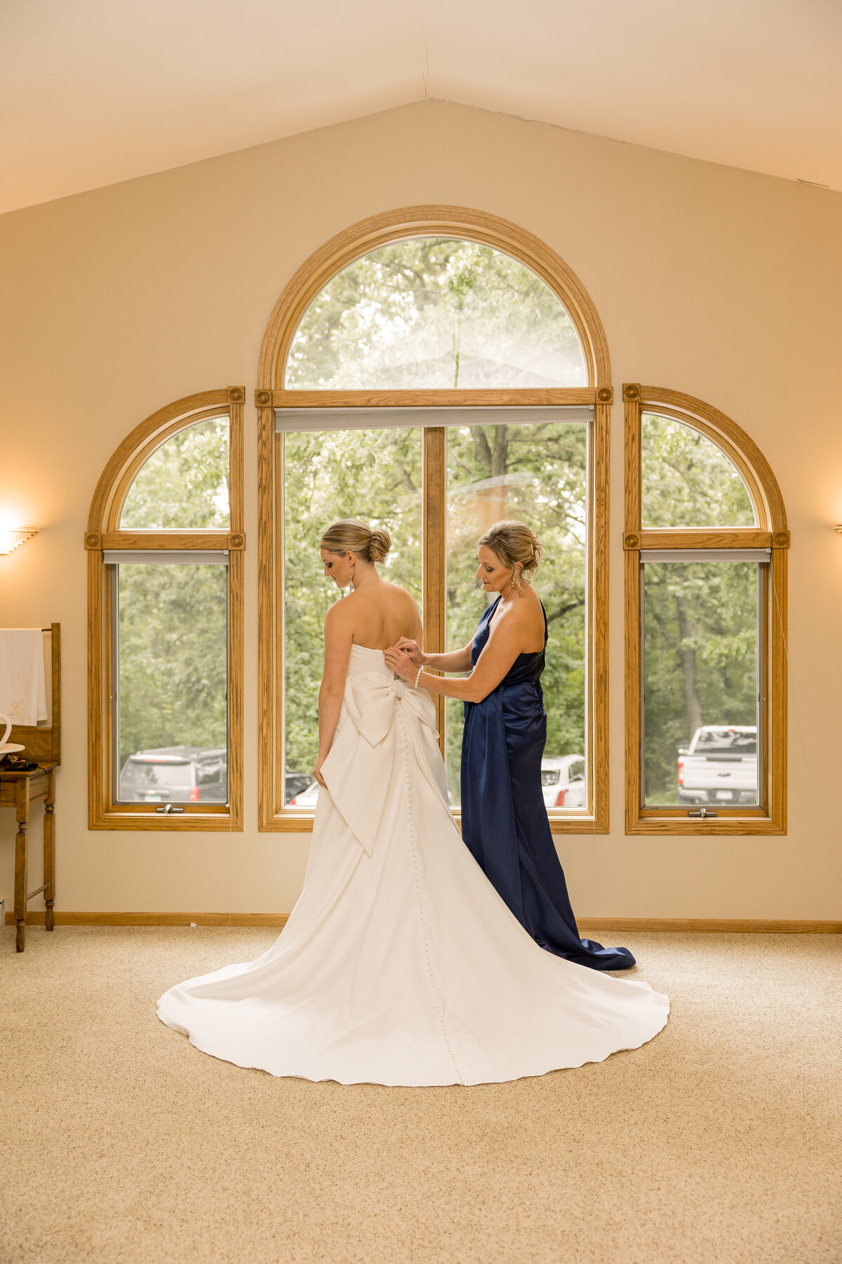Bride getting ready with her mom for her wedding day in Central MN