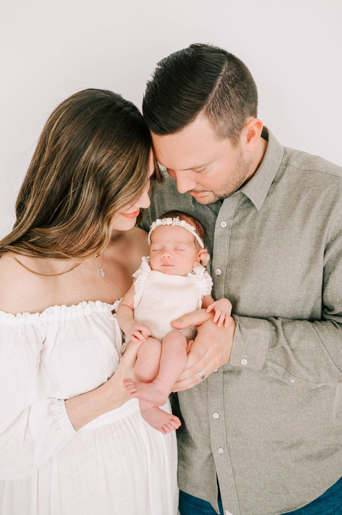 Springfield MO newborn photographer captures parents holding newborn baby girl