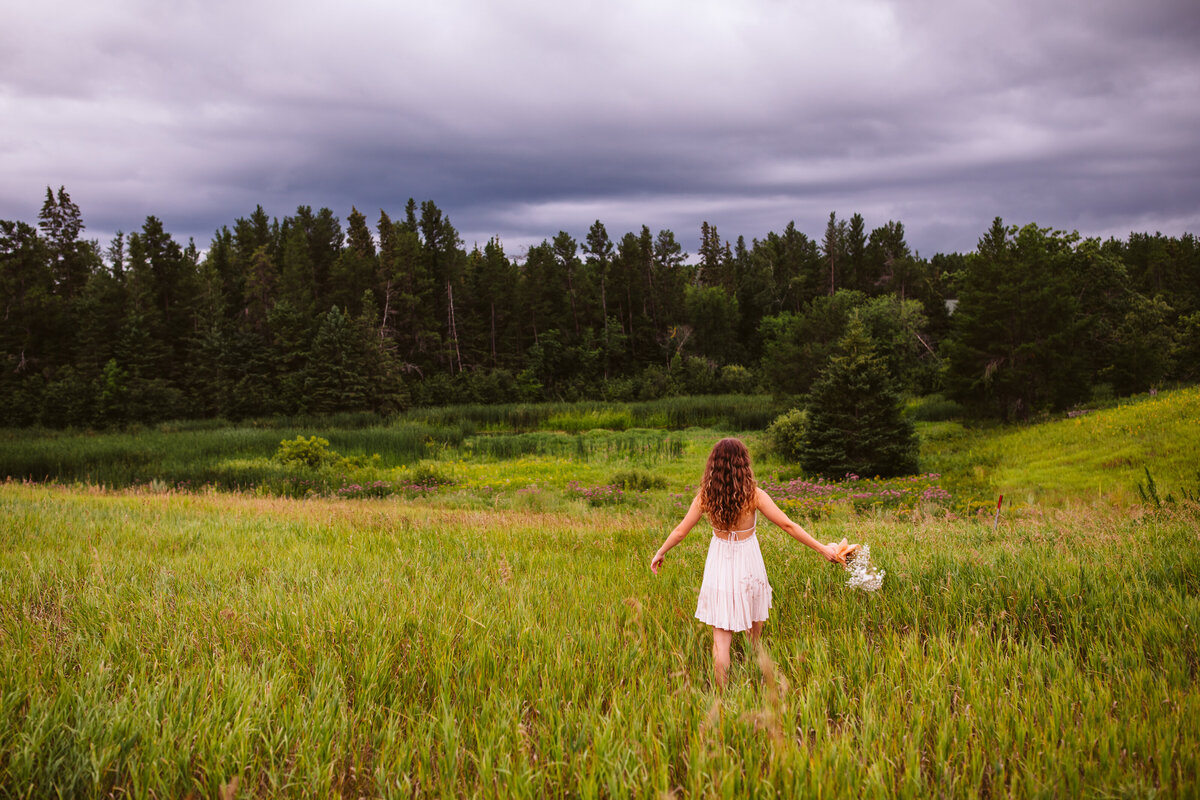 Girl walking in tall grass - Park Rapids, Minnesota