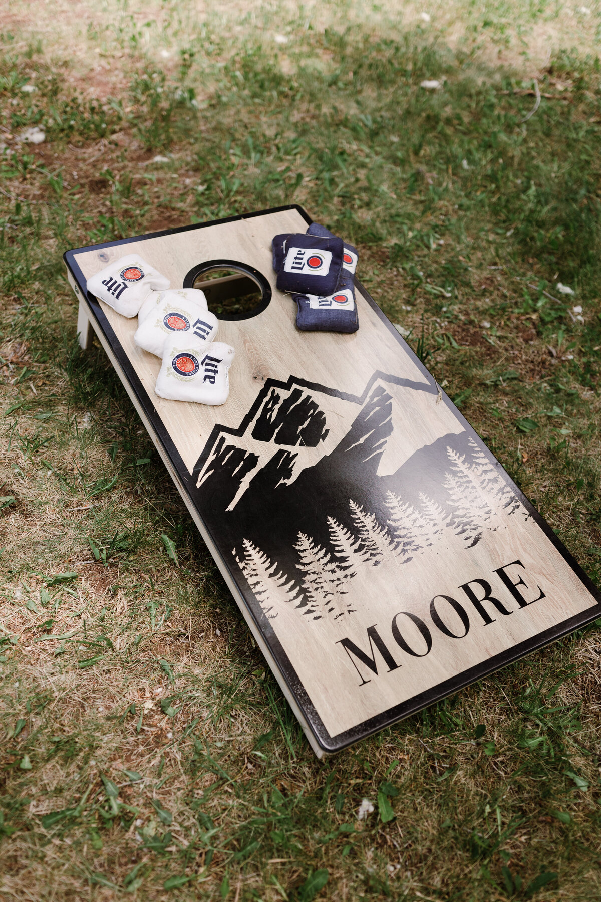 Cornhole board with mountains painted on it at Dallenbach Ranch Colorado Wedding