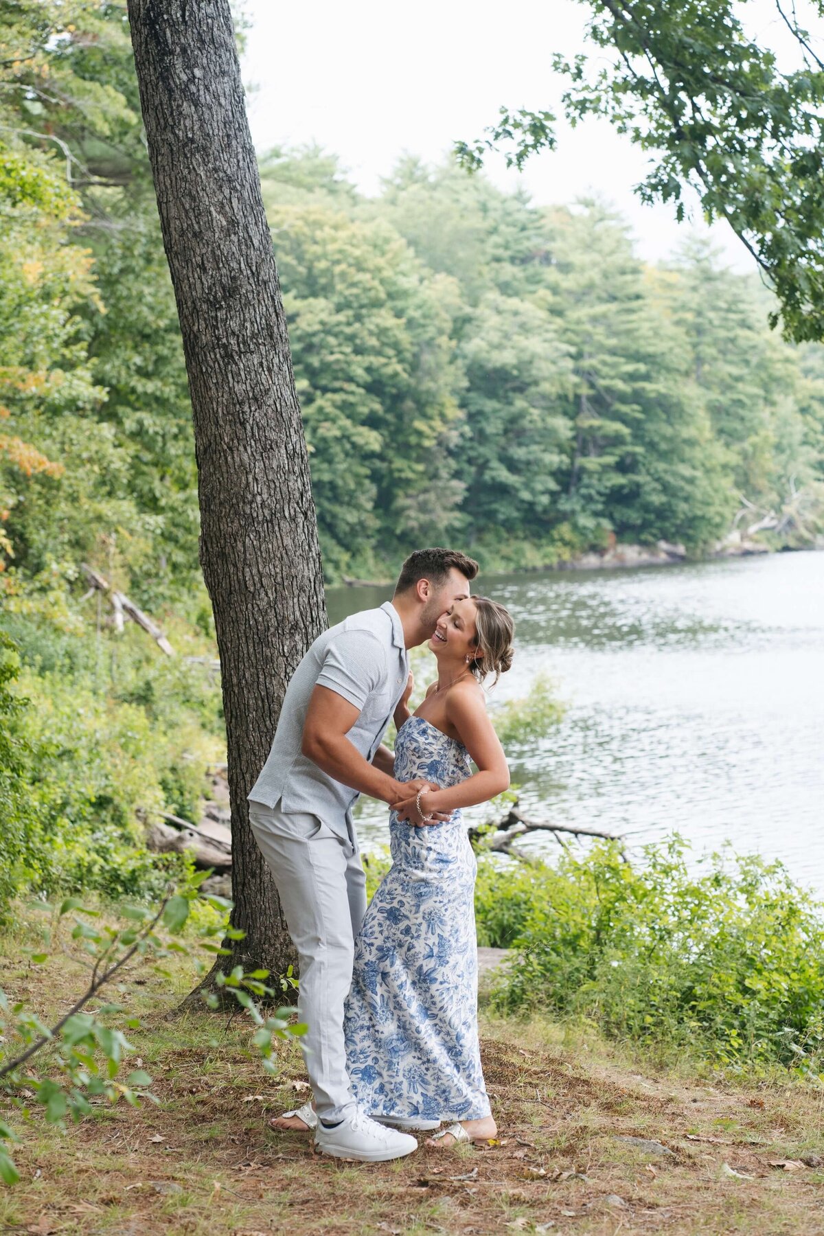 couple getting engagement photos done near water