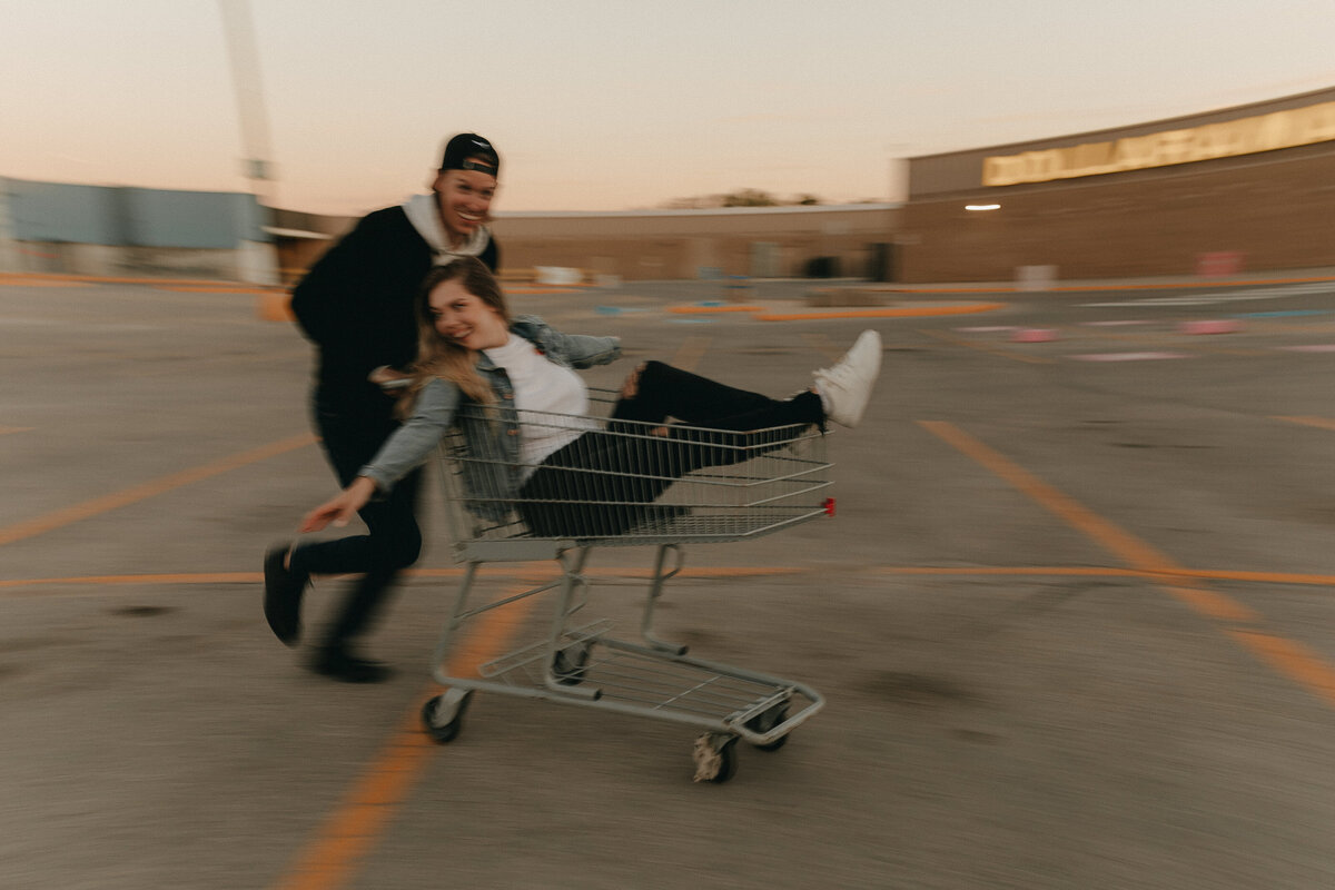 couple riding in grocery cart