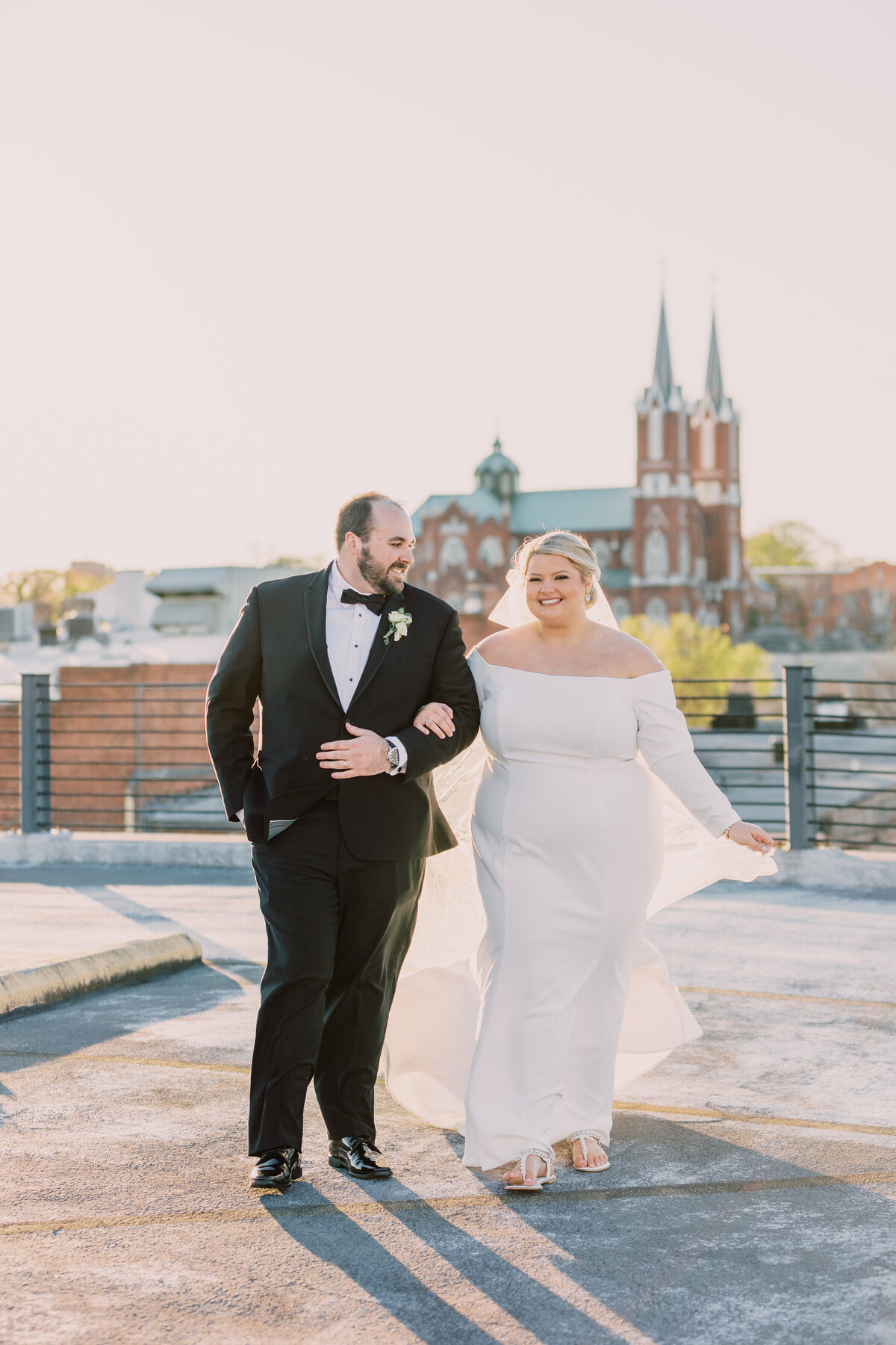 bride and groom with church spires in background