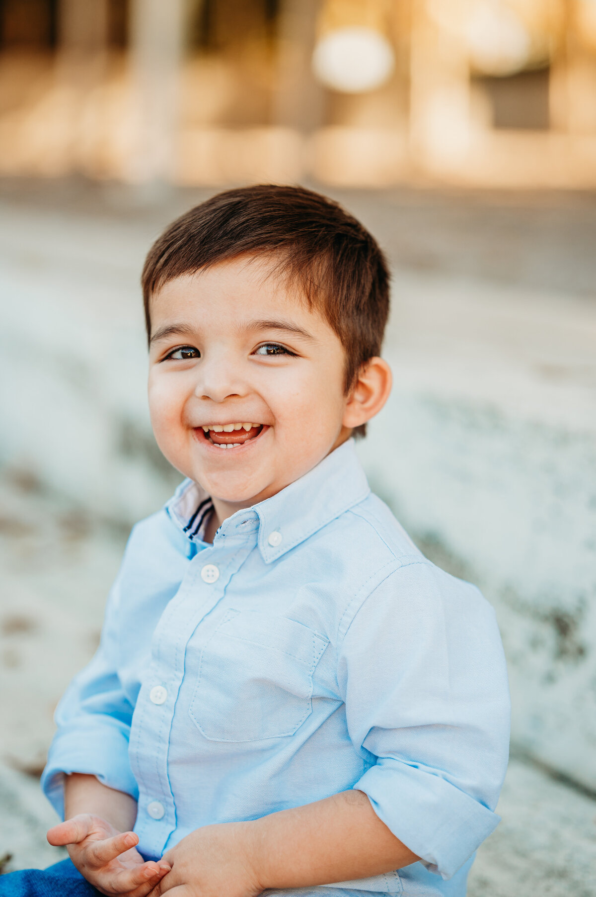 Young boy smiling brightly during outdoor family session — playful Dallas–Fort Worth family photography by Poppy + Blue Photography