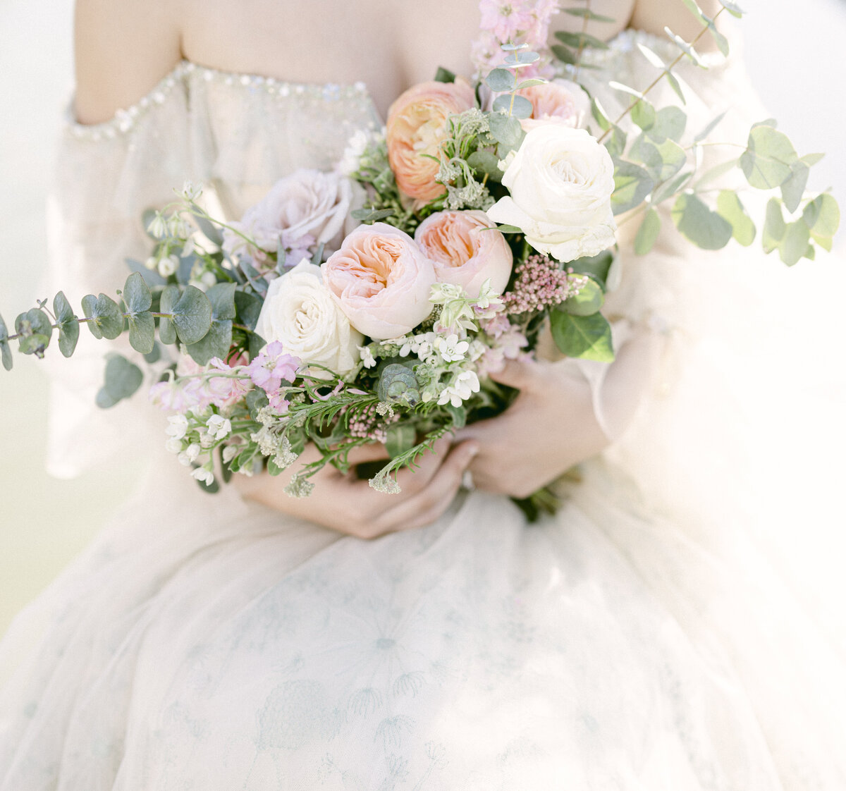 bride-holding-bridal-bouquet-blooming-flowers
